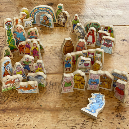 Set of wooden classic story scene pieces on a wooden surface