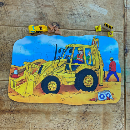 Children's puzzle with a Digger construction scene featuring a bulldozer on a wooden surface.