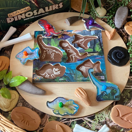 Dinosaur fossil -t hemed playset with toy figures and packaging on a wooden surface.