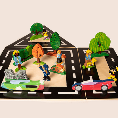 Toy road set with figurines and a car on a beige background