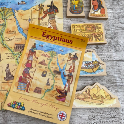 Egyptian-themed educational toys and game on a wooden surface