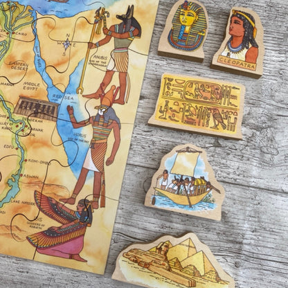 Set of wooden stamps with Egyptian-themed designs on a wooden surface
