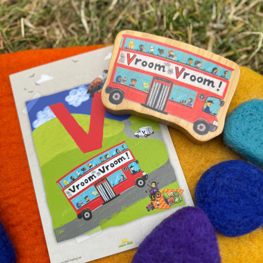 Wooden toy bus with 'Vroom Vroom!' text on a grassy background
