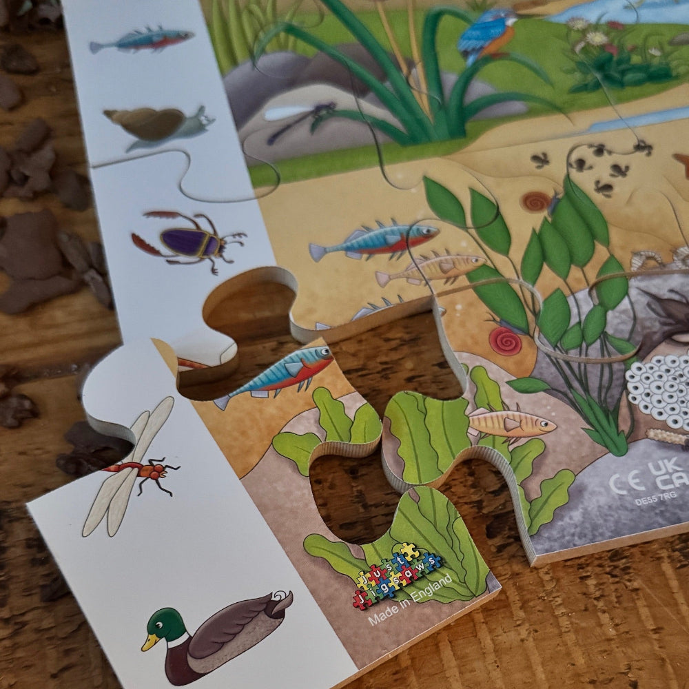 Children's puzzle with pond illustrations on a wooden surface
