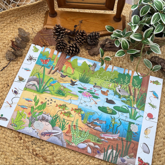 Children's pond-themed puzzle on a woven surface with decorative elements.