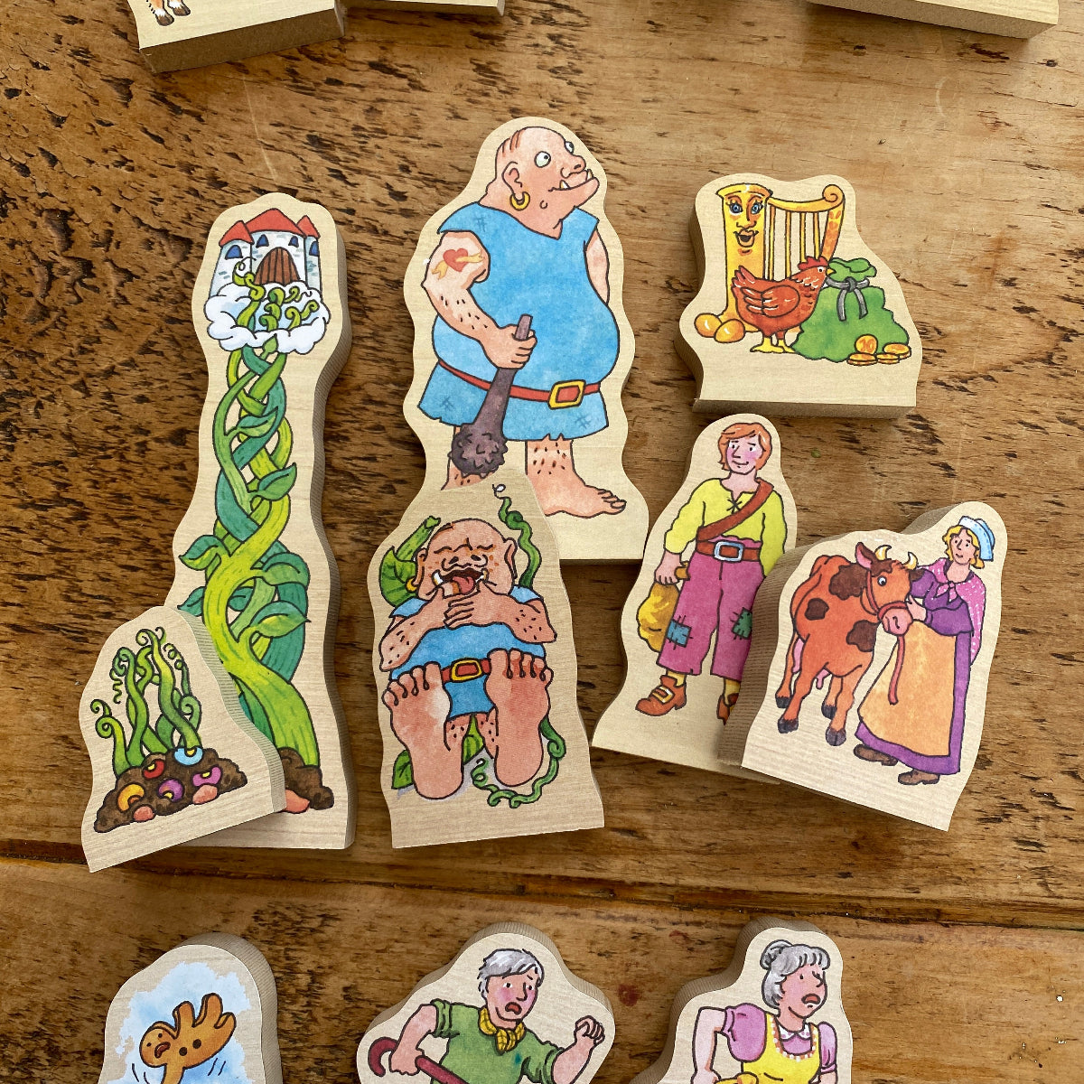 Wooden figurines with colorful designs on a wooden surface