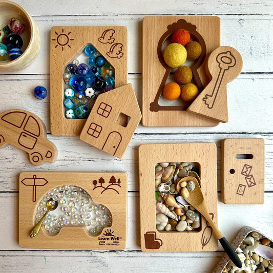 Set of wooden educational toys with various shapes and designs on a wooden surface.