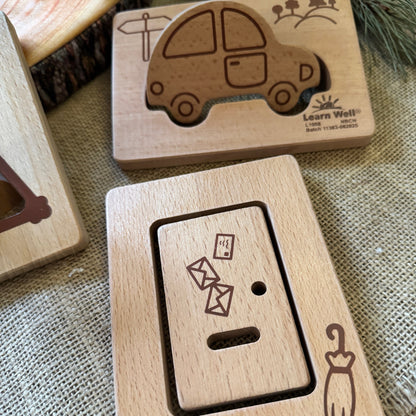 Wooden Shapes with engraved illustrations on a textured fabric background