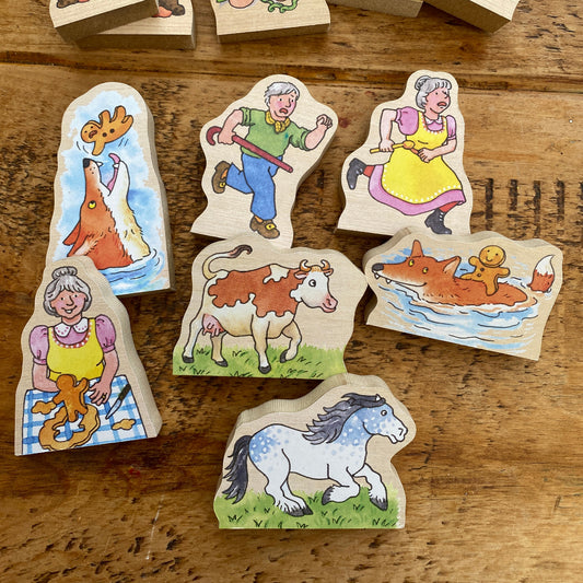 Wooden toys with colorful illustrations of animals and people on a wooden surface