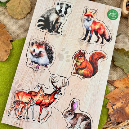 Wooden forest animal puzzle with a nature-themed background including pinecones and mushrooms.