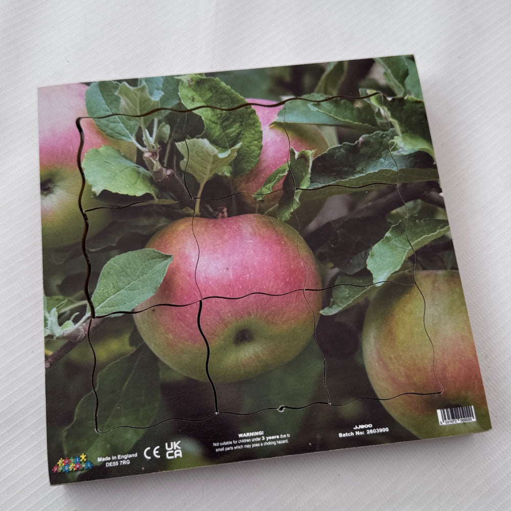 Jigsaw puzzle with an image of apples on a white surface