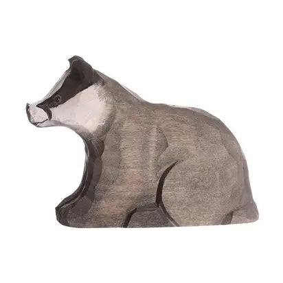 Hand carved Wooden badger figure on a white background
