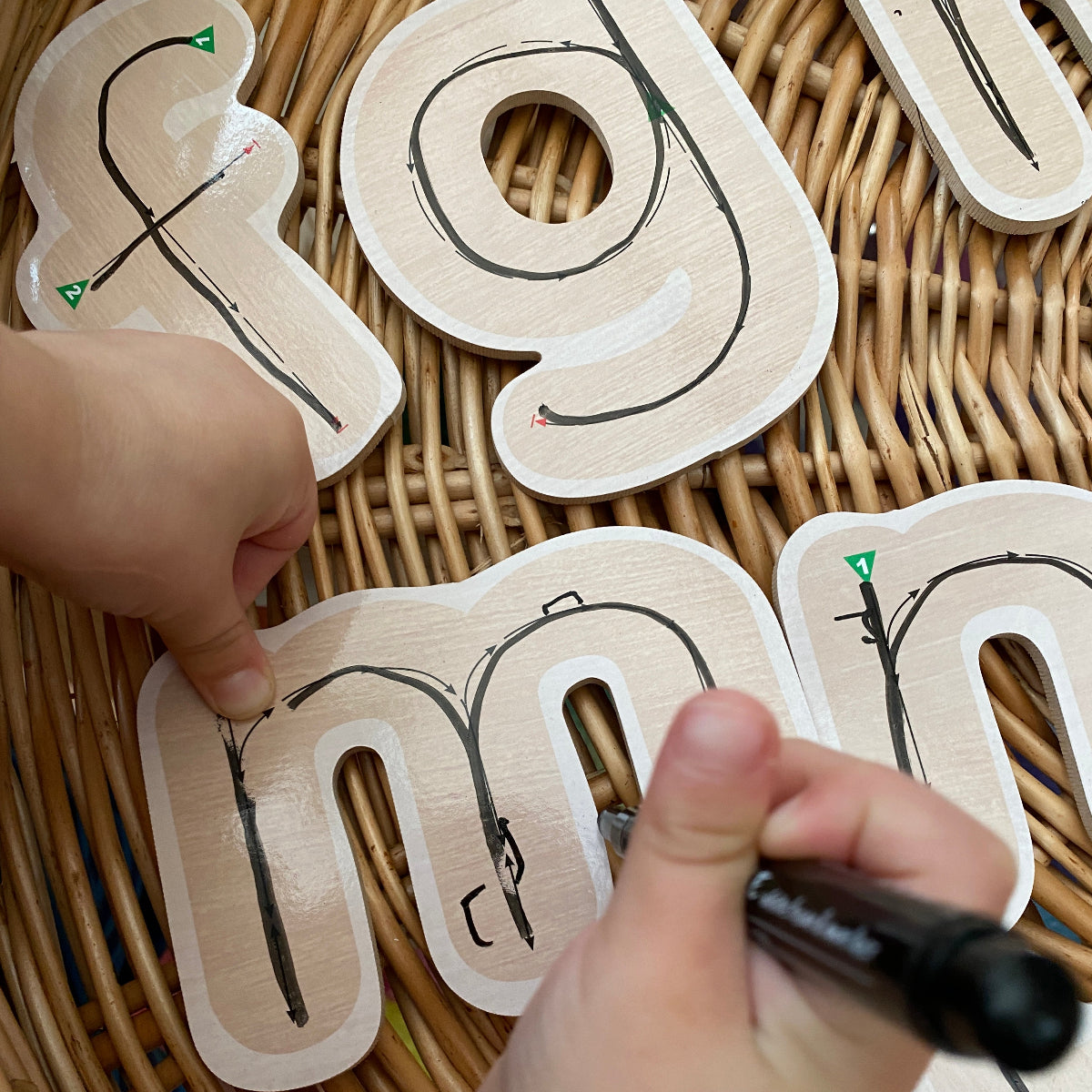 Children's educational toy with letters on a wicker surface