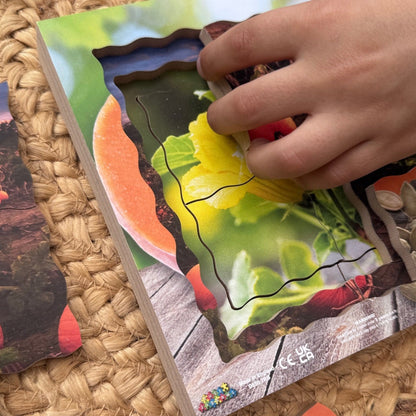 Hand interacting with a colorful puzzle on a woven surface