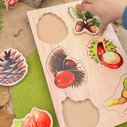 Wooden puzzle with forest-themed pieces on a rustic surface with pinecones and mushrooms.