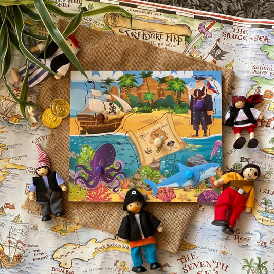 Toy figures on a map with a pirate-themed book