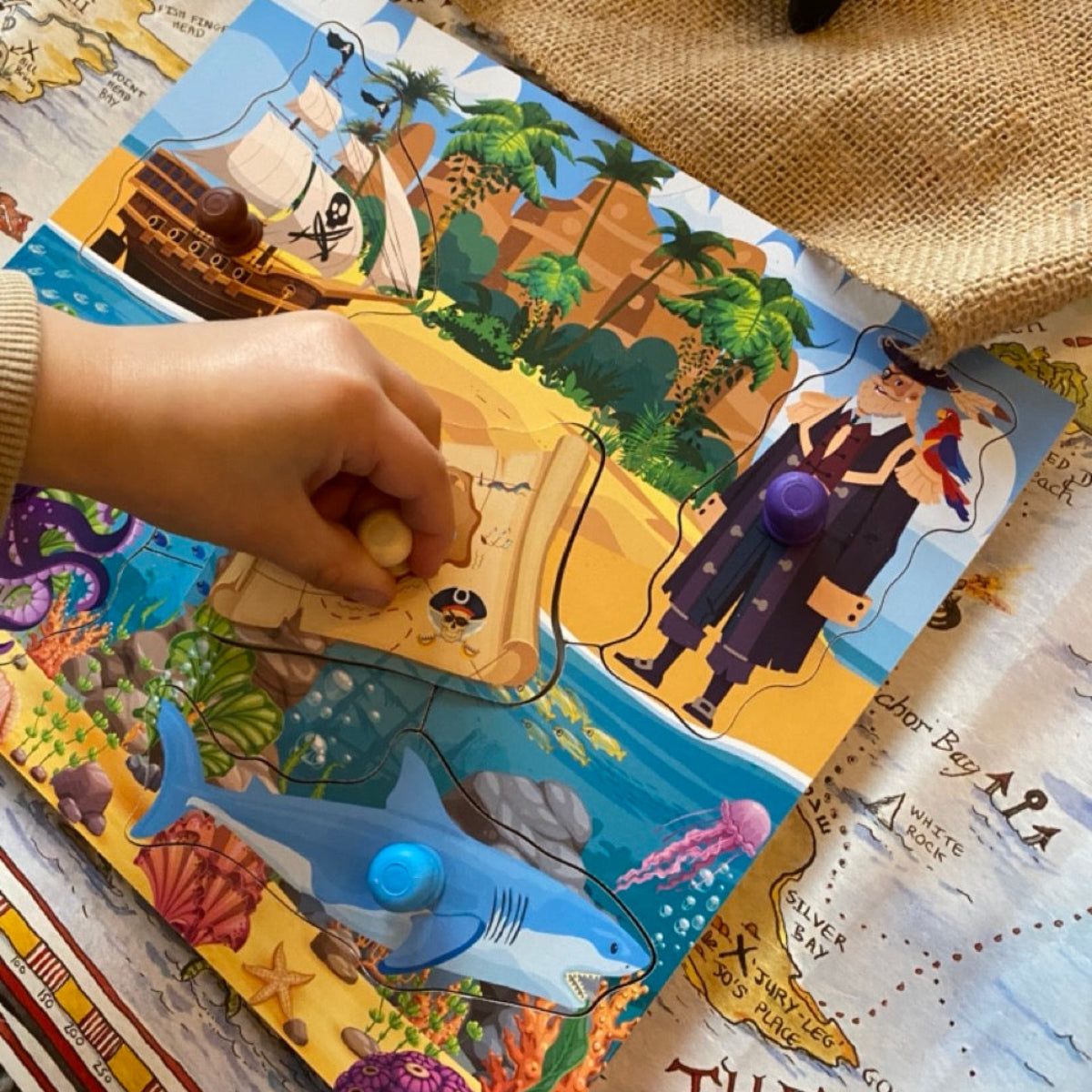 Children's pirate-themed board game with colorful illustrations on a map background
