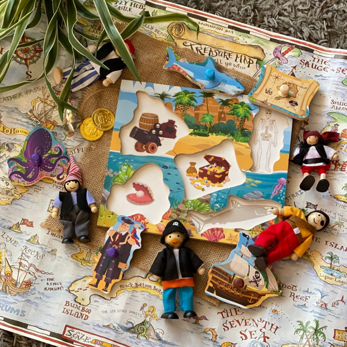 Pirate-themed board game with figures and map on a textured surface