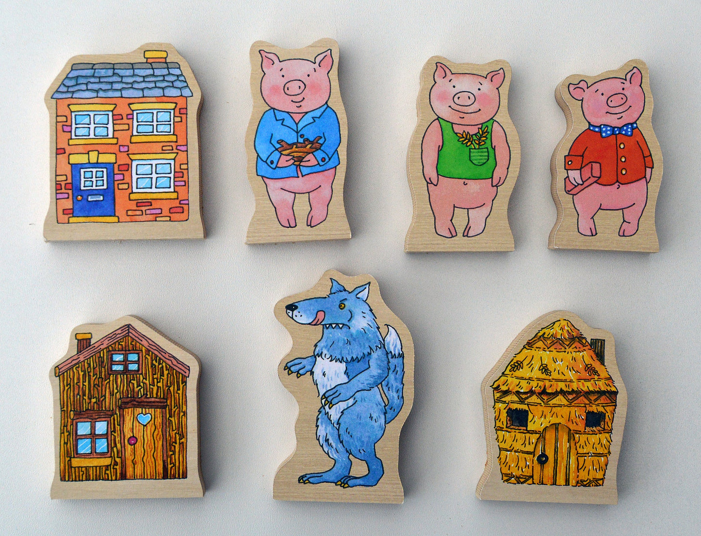 Wooden toys featuring characters from a children's storybook on a white background